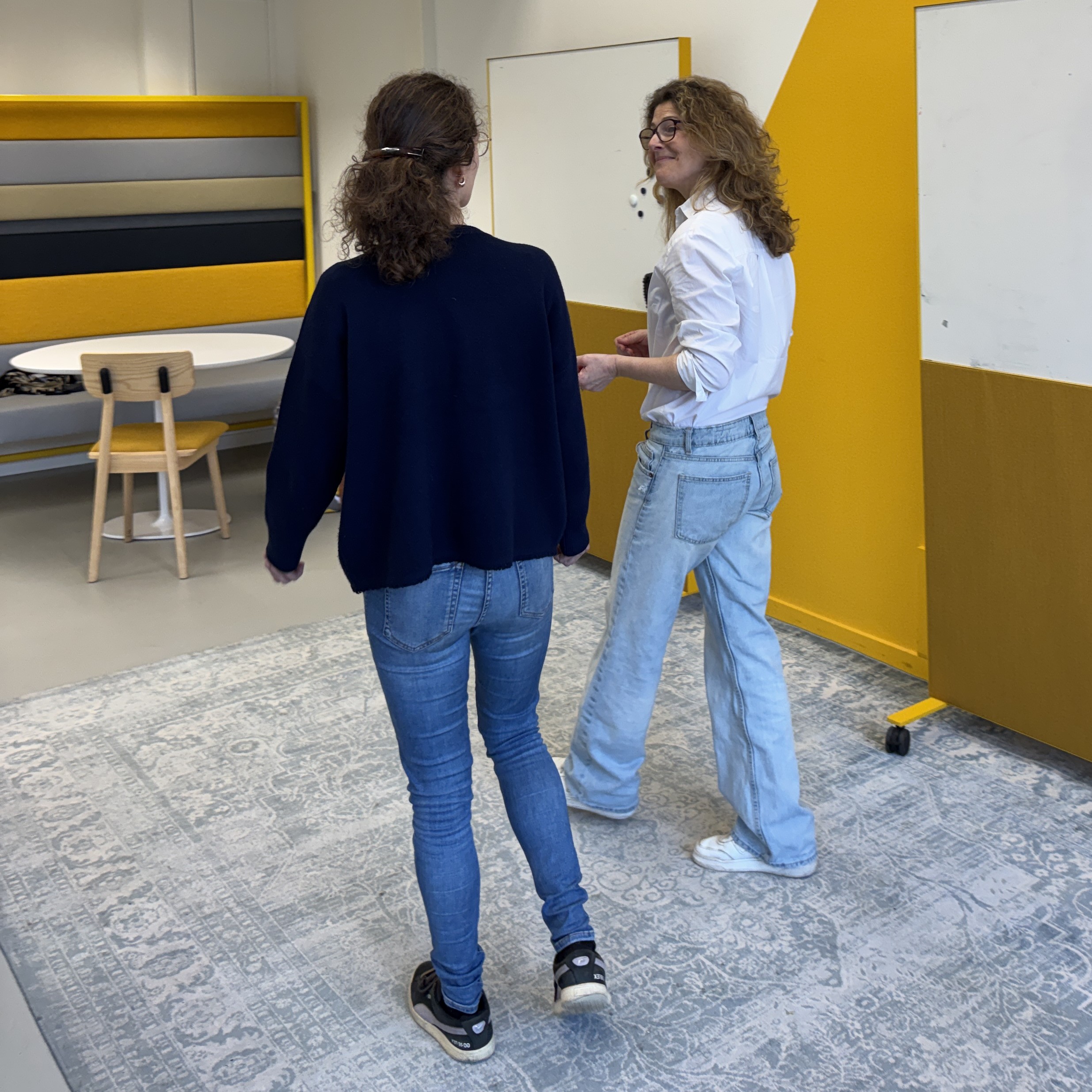 Two colleagues discussing progress after a coaching session